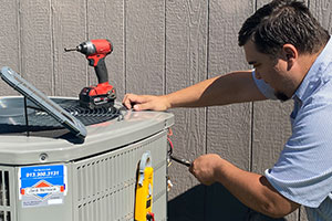 Contractor repairing air conditioning unit