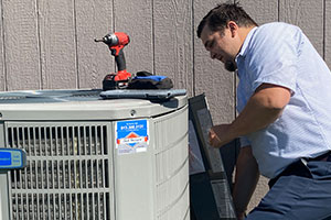 Contractor installing air conditioning unit